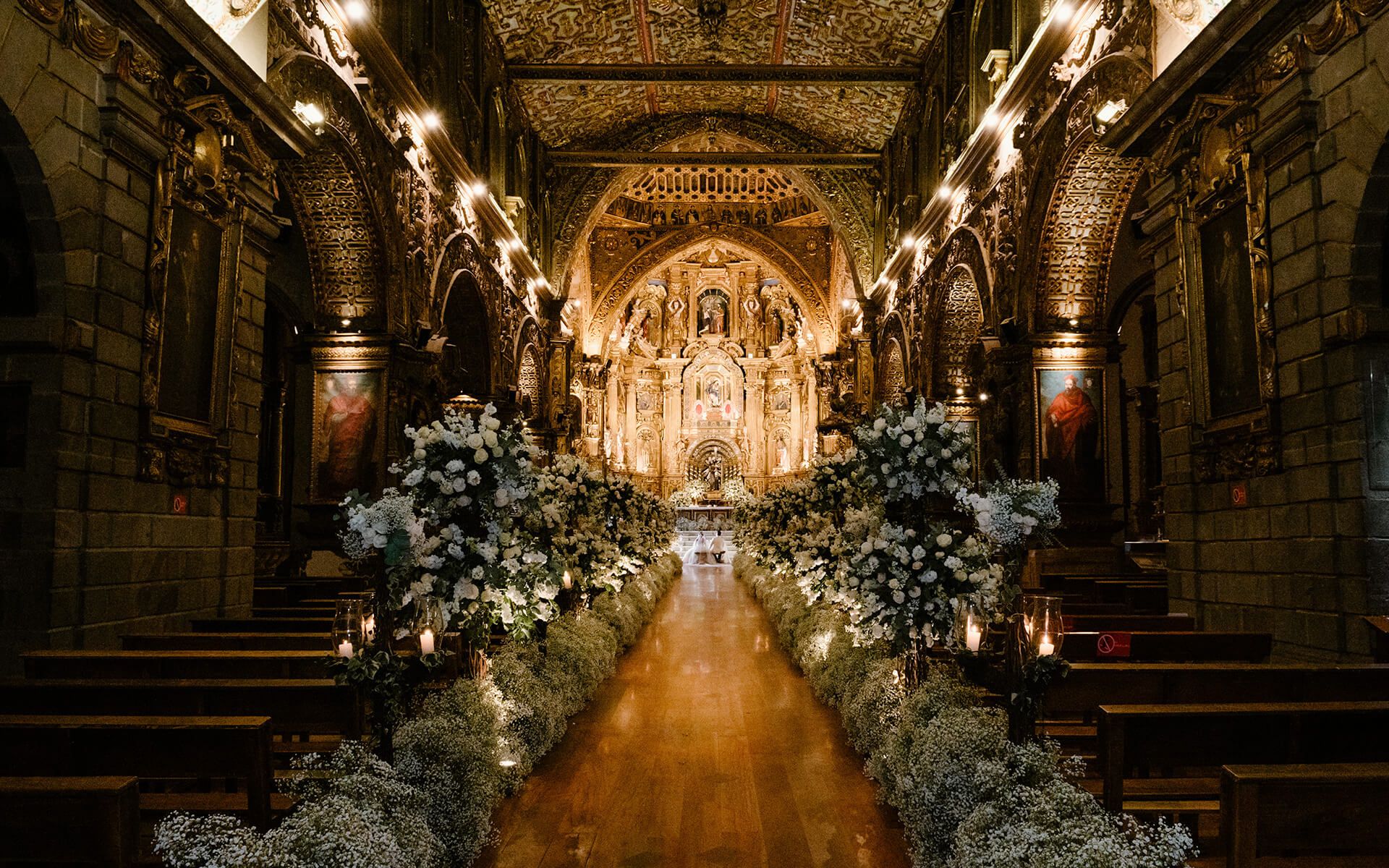 Colonial church aisle decorated with white flowers for a wedding in Quito