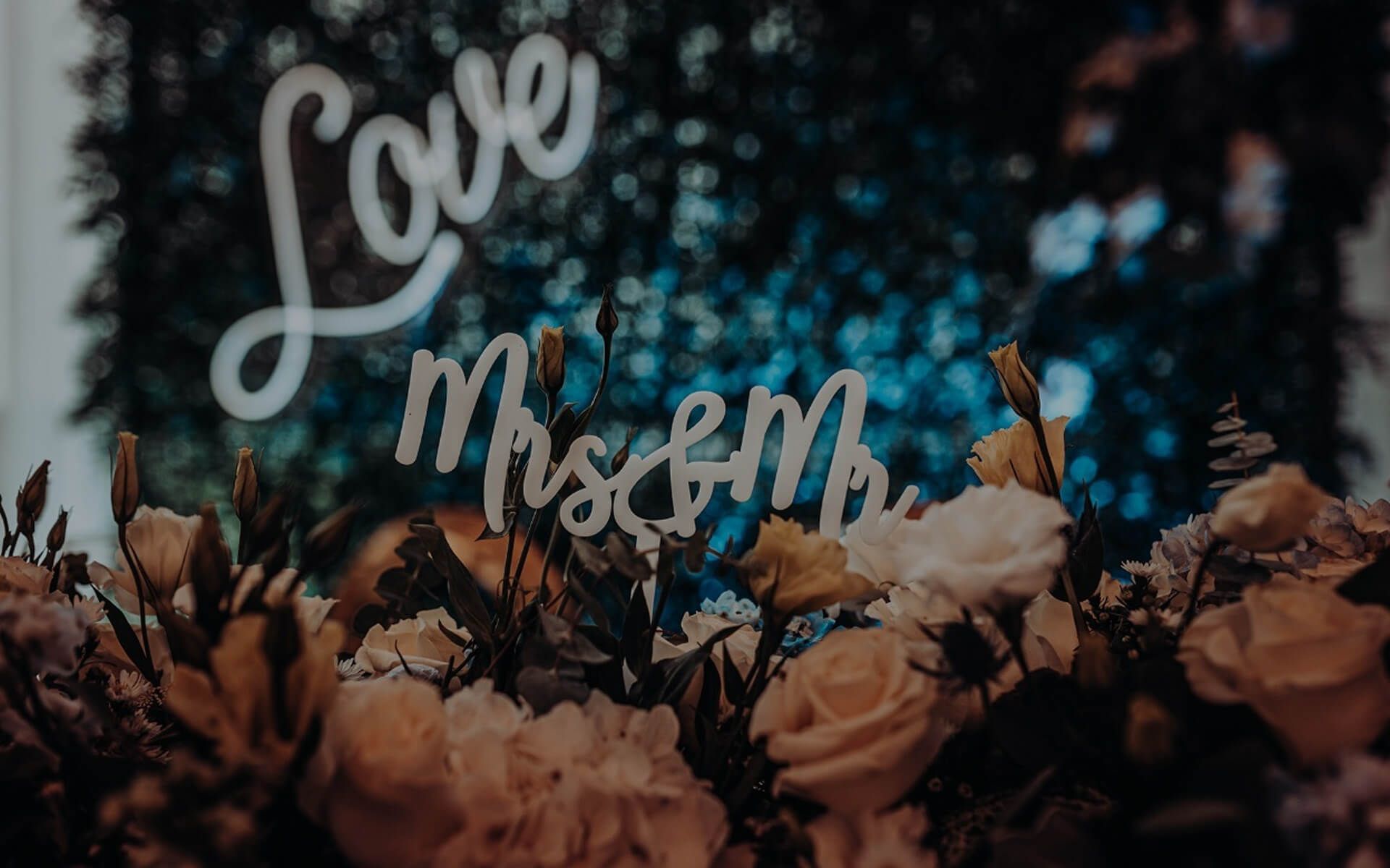 Love neon sign over flowers