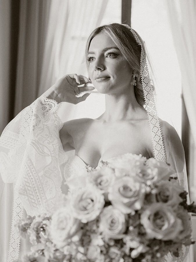Bride holding a bouquet of white roses