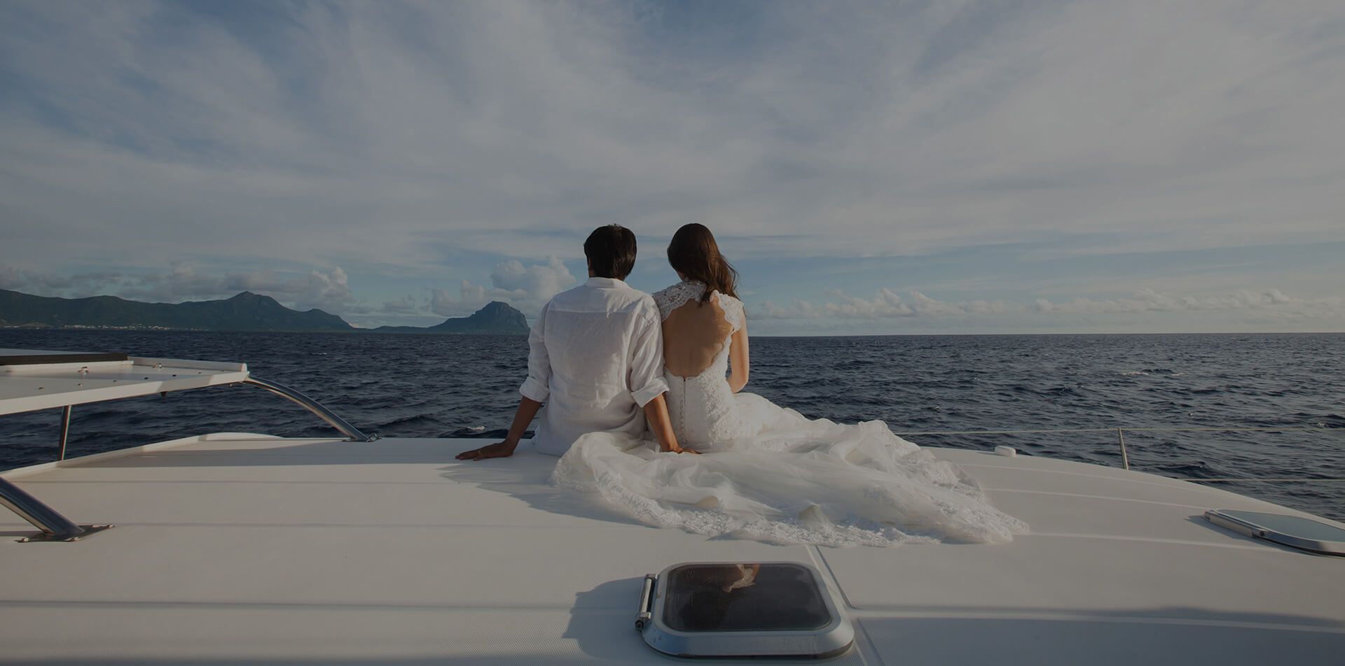 Couple on the bow of a yacht in Galápagos